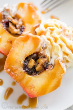 two pieces of apple pie on a plate with ice cream and caramel drizzle