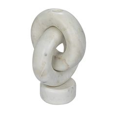 a white sculpture sitting on top of a marble base with a knot around it's center