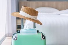 a suitcase with a straw hat on top