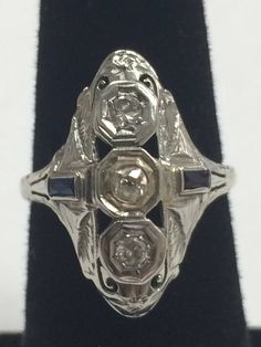 "Vintage 1940's 14K White Gold .50CTW Diamond and Sapphire Ring This beautiful, well made ring will become a family heirloom! 2 round .15ct diamonds set in a row with 2 - .3ct sapphires on side of band. Ring face measures approximately 1\" x 1/2\" Size 6.25 3.1 grams total weight. In excellent vintage condition!" Diamond And Sapphire Ring, Black Opal Pendant, Black Gift Boxes, Cute Rings, Family Heirloom, Multi Stone Ring, Opal Pendants, Star Pendant, Black Opal