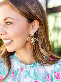 Blossom into spring with our timeless Alani Earrings. Featuring an organic shaped flower stud, these earrings introduce a delicate touch of floral sophistication to your everyday outfit. Organic shaped flower stud earrings 2.25" Brass plated Hypoallergenic Surgical steel posts Nickel and lead-free Feminine Drop Earrings For Spring, Gold Flower-shaped Earrings For Spring, Chic Spring Flower Earrings For Pierced Ears, Feminine Petal-shaped Jewelry For Spring, Spring Gold Flower-shaped Earrings, Chic Flower Charm Drop Earrings, Feminine Flower Shaped Jewelry For Spring, Feminine Flower-shaped Jewelry For Spring, Chic Drop Earrings With Flower Charm