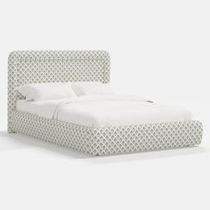 a white bed with an intricate headboard and foot board in the shape of a heart