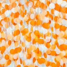 an orange and white background with lots of circles on the top, in different colors