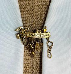 a close up of a tie with a pin on it