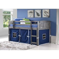 a bunk bed with blue sheets and curtains