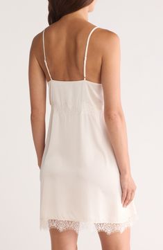 Feel your most glamorous through your morning and nighttime routines in this satin chemise trimmed in delicate lace. 25" center front (size medium) V-neck Adjustable straps 100% polyester Machine wash, dry flat Imported Elegant Chemise With Built-in Bra And Spaghetti Straps, Wedding Night Chemise With Built-in Bra And Spaghetti Straps, Feminine V-neck Slip Dress With Delicate Straps, Coquette Lace Trim Slip Dress For Night, Coquette Night Slip Dress With Lace Trim, Lace Slip Dress With Built-in Bra For Daywear, Summer V-neck Nightgown With Delicate Lace, Wedding V-neck Camisole With Delicate Straps, Lace Sleepwear With Delicate Straps And V-neck