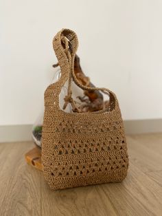 a crocheted purse sitting on top of a wooden table