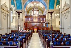 the inside of a church with rows of pews