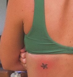 a woman with a starfish tattoo on her back