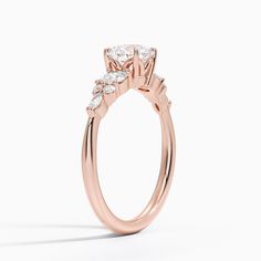 a rose gold engagement ring with three stones