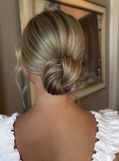 a woman with blonde hair in a low bun