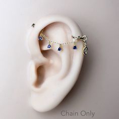 a pair of ear piercings with blue beads