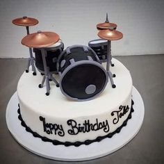 a birthday cake with a drum set on top