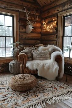 a living room filled with furniture and lots of wood paneled walls, along with deer head mounted on the wall