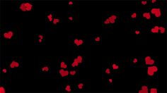 red hearts floating in the air on a black background