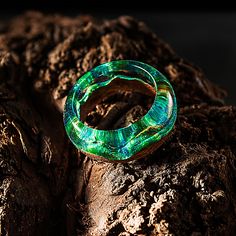 a green ring sitting on top of a tree stump