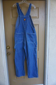 "Vintage blue denim overalls by Big Ben. Labeled a size 36 X 30. Condition - see photos Measurements taken across front lying flat 20\" across front of waist 23\" across hips 34\" inseam" Full Length Medium Wash Cotton Overalls, Full Length Medium Wash Overalls With Pockets, Medium Wash Overall Pants With Pockets, Dark Wash Full Length Overalls With Pockets, Denim Blue Bib Front Overalls, Vintage Denim Blue Overalls With Pockets, Dark Wash Full-length Overalls With Pockets, Blue Denim Overalls, Blue Full-length Cotton Overalls