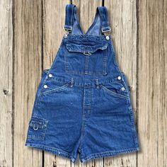 These blue jean overalls by No Boundaries are in good preowned vintage condition! Check out all photos to see. Carpenter style pockets. Tag Size is Medium in JRs but, check out measurements below to ensure an accurate fit Comes from a smoke free home Fast handling time for faster shipping Measurements taken laid flat and in inches Waist: 15.5 inches (31 inches around) Rise: 12 inches Hips: 20 inches (40 inches around) Leg Opening: 12 inches (24 inches around) Inseam: 3 inches Cheap Vintage Denim Blue Overalls, Cheap Denim Blue Cotton Shortalls, Vintage Denim Blue Overalls With Pockets, Vintage Denim Blue Cotton Shortalls, Vintage Blue Cotton Shortalls, Blue Vintage Cotton Shortalls, Retro Dark Wash Shortalls With Pockets, Vintage Dark Wash Shortalls With Pockets, Retro Blue Shortalls With Pockets