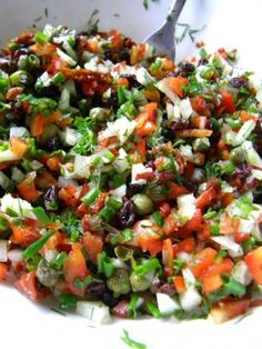 a white bowl filled with lots of different types of food and garnishes