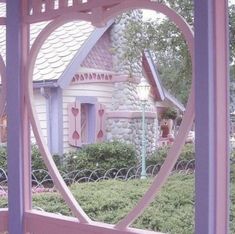 there is a pink and purple house in the shape of a heart