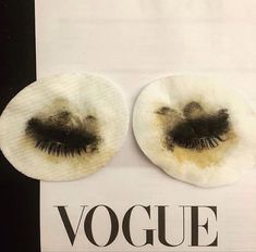 two pieces of fake eyelashes on top of a piece of paper with the word voque written below it