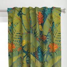 the curtains are hanging on the window sill in front of the curtain with tropical print