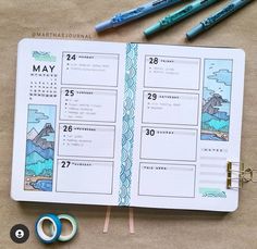 an open planner with some scissors and markers