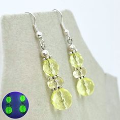 Stunning yellow jonquil Uranium glass crystal bead drop earrings. These gorgeous earrings are made using a duo of excellent quality yellow Czech Firepolished crystal beads top and bottom of a jonquil glass rondelle bead Finished with silver plated ear hooks. The beads glow super bright under UV light suggesting the presence of Uranium. Details -  Drop - 3.2cm (excluding ear wire) Metal - Silver plated alloy This piece of jewellery has been handmade using vintage components and vintage beads / cr Neon Yellow Drop Earrings As A Gift, Beaded Top, Beaded Drop Earrings, Silver Drop Earrings, Vintage Yellow, Gorgeous Earrings, Blue Glass, Crystal Beads, Jewelry Earrings Dangle