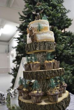 a christmas tree with cupcakes on it and an animal cake in the middle