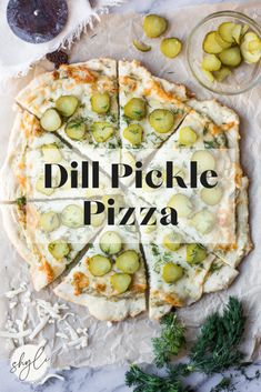 a pizza sitting on top of a table covered in cheese and pickle toppings