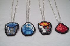 four necklaces that are made out of pixelated video game character beads and silver chains