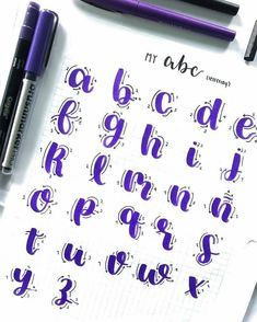 the upper and lower letters are in purple ink, with some black marker pens on top