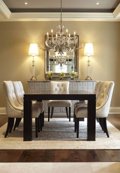 a dining room table with chairs and a chandelier