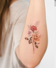 a woman with a flower tattoo on her arm