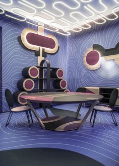 an artisticly designed dining room with blue and purple walls