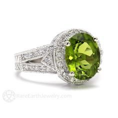 An absolutely gorgeous vintage inspired Peridot and diamond ring in your choice of 14K White, Yellow or Rose Gold. This ring has a stunning 3ct natural Peridot center stone and sparkling conflict free natural diamonds, hand milgrain detailing and beautiful filigree and engraved design. Beautiful! Peridot is the birthstone for August. Official Website: www.RareEarthJewelry.com SCHEDULE This ring is made to order and will take approximately 3 to 4 weeks to complete. No rushes or exceptions. Due to Elegant Peridot Diamond Ring, Luxury Oval Peridot Rings, Classic Peridot Diamond Ring, Elegant Peridot Diamond Ring With Center Stone, Classic Peridot Gemstone Diamond Ring, Wedding Jewelry With Brilliant Cut Peridot, Formal Oval Peridot Diamond Ring, Classic Peridot Jewelry With Brilliant Cut, Classic Peridot Jewelry With Halo Setting