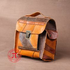 The new design of backpack is simple and nice.  It is made Conecting more than 200 different pieces in combination of brown colours. The genuine cow leather that is used, is in thickness 2 mm. Has an extra pocket in front for the money/wallet and for thngs we want to be necessary separated, both of two sides has a pocket, one for the cell phone. At the back there one more zippered pocket. It is designed and made for everyday use. Brown Shoulder Bag With Luggage Sleeve For Everyday Carry, Brown Shoulder Bag With Luggage Sleeve For Everyday, Brown Leather Patch Satchel Bag, Brown Satchel Bag With Leather Patch, Rectangular Brown Shoulder Bag With Leather Patch, Brown School Backpack With Luggage Sleeve, Brown Rectangular Shoulder Bag With Leather Patch, Brown Leather Backpack With Leather Patch, Brown Leather Backpack With Luggage Sleeve For Everyday