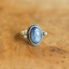 We are very excited about the look and feel of our new Deep Blue Kyanite Lasso Ring! This Boho Blue Kyanite Ring looks and feels great - you won't want to take it off! Perfectly balanced with a healthy sized 10X14mm Blue Kyanite stone, .925 Sterling silver accents and half-round shank - super comfortable and easy to wear. This ring's all sterling silver details are unique and truly set off the stone! You might want to make room on your hand -- you're going to want to wear this Blue Kyanite State Adjustable Blue Ring With Gemstone Accents, Blue Rings With Large Stone For Healing, Celestial Sapphire Sterling Silver Rings, Celestial Sapphire Ring In Sterling Silver, Celestial Blue Gemstone Rings, Spiritual Sapphire Oval Rings, Celestial Style Blue Oval Ring, Celestial Blue Oval Ring, Celestial Sapphire Gemstone Ring