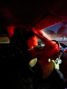 two people sitting in the passenger seat of a car at night