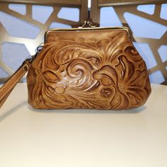 Patricia Nash Tooled Leather Wristlet. 2 Inside Credit Card Slots, One Inside Slip Pocket & Zip Pocket. Never Used. 6.5"H 8.5"L Daily Use Coin Purse Clutch, Brown Clutch Pouch With Wrist Strap, Leather Wristlet With Removable Pouch, Brown Handheld Clutch As A Gift, Brown Handheld Clutch As Gift, Brown Clutch With Wrist Strap For Daily Use, Handheld Coin Purse For Daily Use, Brown Mobile Phone Pouch, Brown Leather Clutch Wristlet