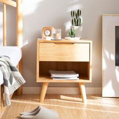 a bedroom scene with focus on the nightstand and shoes in the foreground, along with a bed