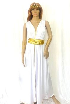 a mannequin wearing a white dress with gold trims and a golden belt