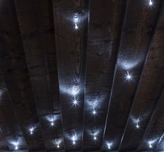 the ceiling is covered with white lights and stars