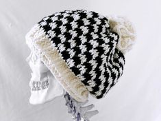 a black and white knitted hat on top of a skull head