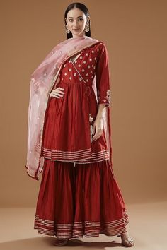 Featuring a red angrakha kurta in chanderi base with gota patti embroidery. It is paired with matching gharara pants and a contrasting organza dupatta. This product will be shipped to you after 1-2 weeks from the date of order placed. All custom made orders are not returnable. Pls contact for Size chart and for other more colors Request You :To provide contact details for courier services. {VARIATION MAY COME DEPENDING UPON AVALIBILITY OF LACES OR GOTTA PATI or TUSSELS} NOTE:  1) Visual Samples on website may differ slightly from actual product due to light & effects during photography (Length & Breadth have 1 n 1.5 inches +/-). 2) Before placing order ,pls confirm product n color availability and  For Wholesale Order MOQ is 5 Pieces of any color/Pattern on +91 7903893945 & +91 8447750028( Gota Patti Embroidery, Gharara Pants, Berry Dress, Designer Kurta, Independance Day, Krishna Janmashtami, Sharara Set, Boho Christmas, Maggie Sottero