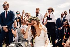 a group of people standing and sitting in front of each other with glasses on their heads