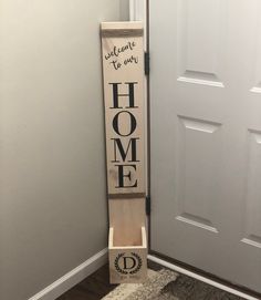 a sign that says welcome to our home on the side of a door way in front of a white door