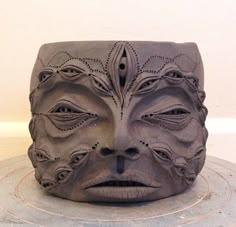 a face made out of clay sitting on top of a table