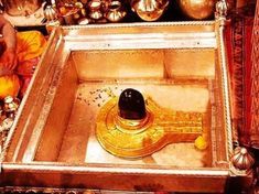 a golden instrument sitting on top of a wooden table