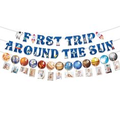 a banner that says first trip around the sun with pictures hanging from it's sides